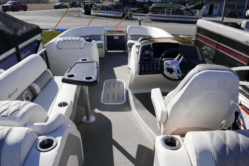 Slide: The Image of Interior of a 2022 Bennington 23 RCW pontoon boat with luxurious seating and steering console. - 16