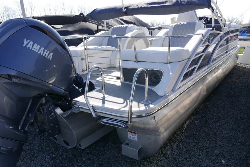 Slide: The Image of 2022 Bennington 23 RCW pontoon boat with Yamaha engine, sleek design, and comfortable seating. - 4