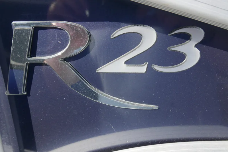 Slide: The Image of Close-up of 2022 Bennington 23 RCW logo on dark surface. - 5