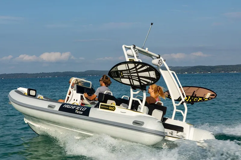 Slide: The Image of Manufacturer Provided Image: 2025 Highfield VELOX 560 boat cruising on a clear blue lake. - 2