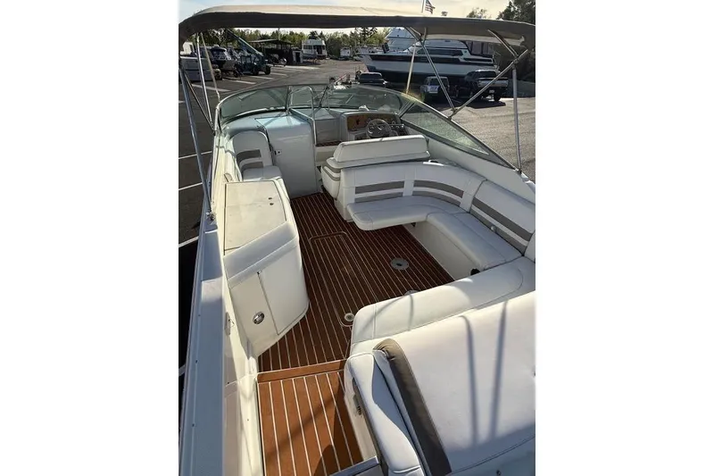 Slide: The Image of 1999 Formula 280 Sun Sport boat interior with white seating and wooden flooring. - 3