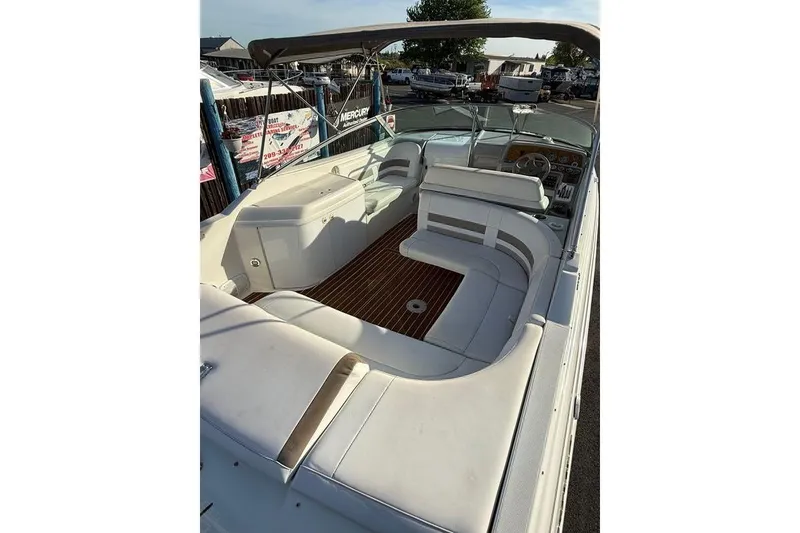 Slide: The Image of 1999 Formula 280 Sun Sport boat interior with white seating and wood flooring. - 4