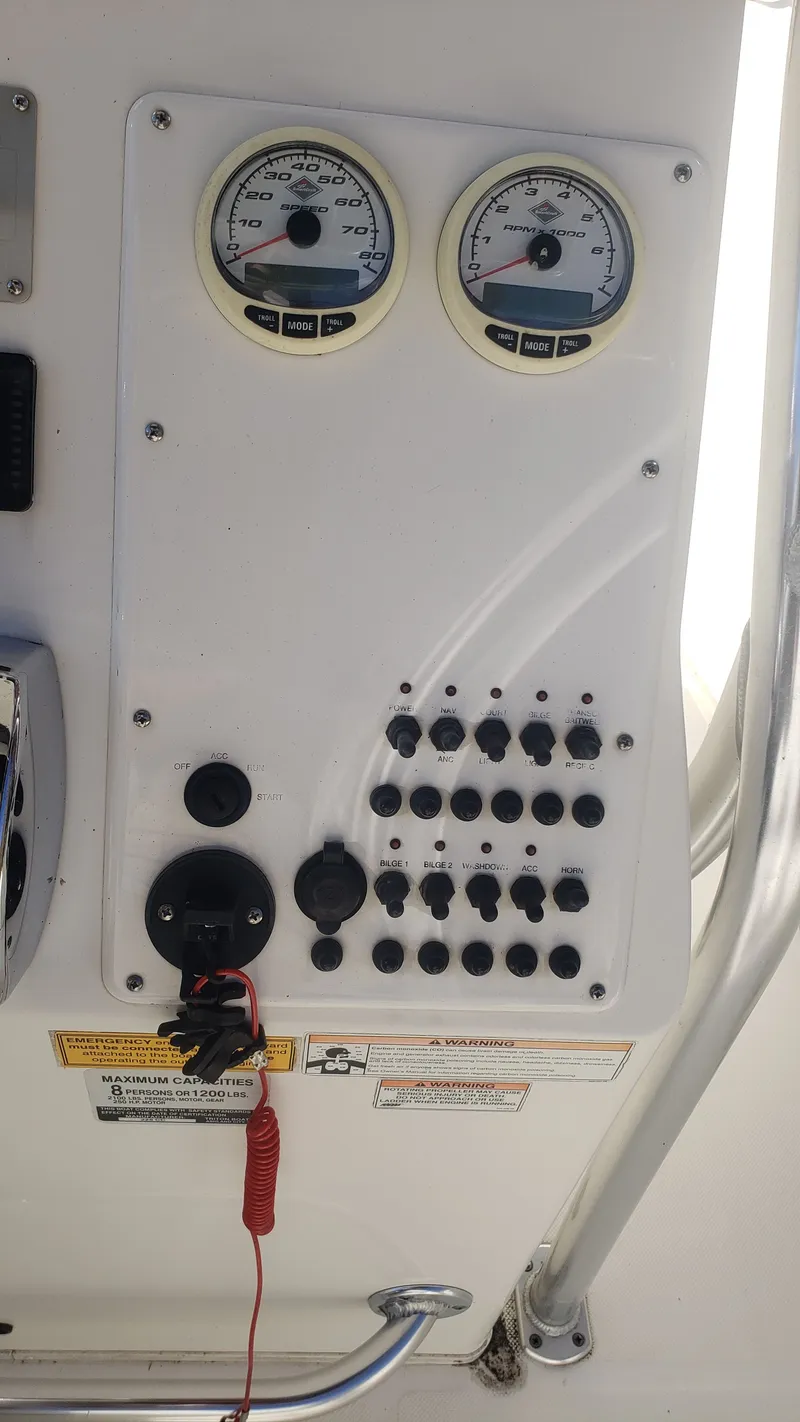 Slide: The Image of Dashboard of a 2009 Triton 225 CC boat with instruments. - 11