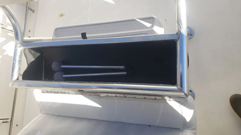 Slide: The Image of Interior view of a 2009 Triton 225 CC boat with storage compartment. - 19