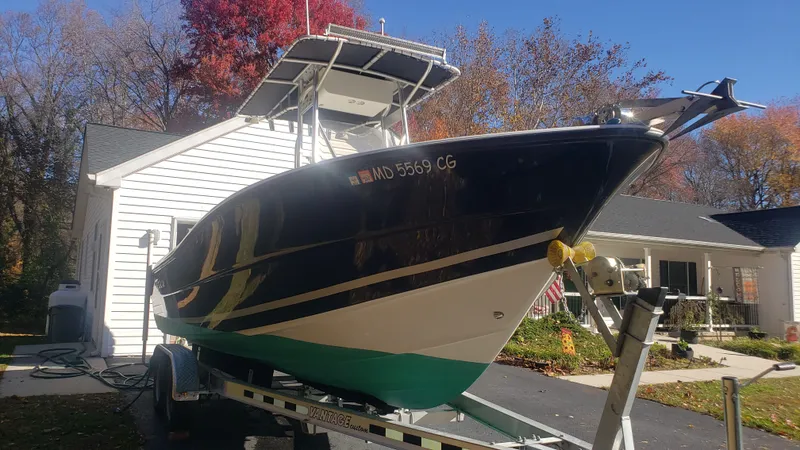 Slide: The Image of 2009 Triton 225 CC boat on trailer in front of house. - 2