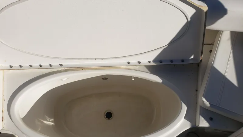 Slide: The Image of Triton 225 CC 2009 boat, open storage compartment. - 22