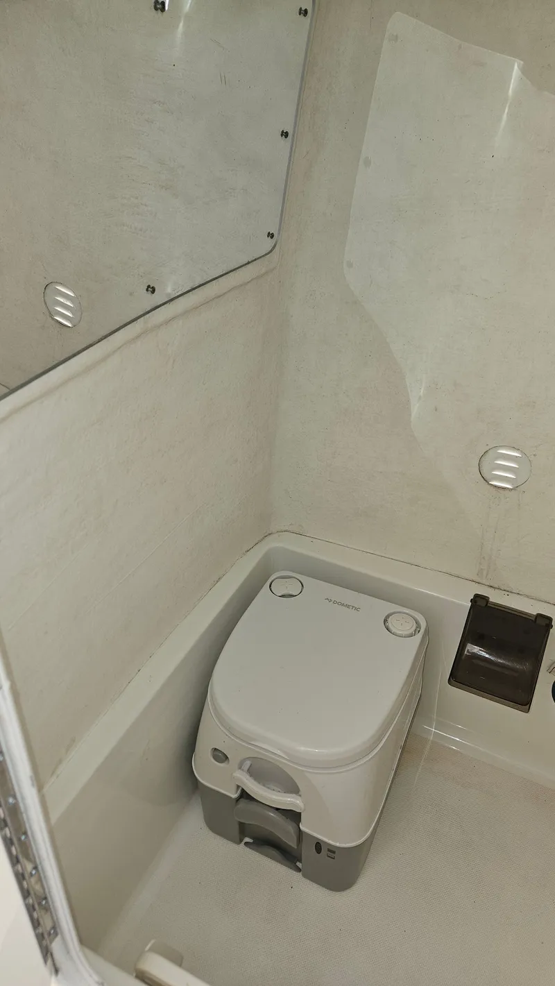 Slide: The Image of Interior of a 2009 Triton 225 CC with portable toilet. - 24