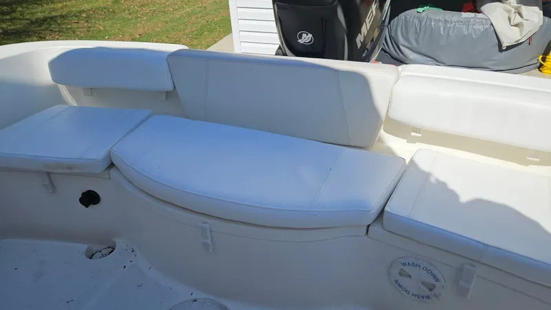 Slide: The Image of Interior of a 2009 Triton 225 CC boat with white seating. - 28