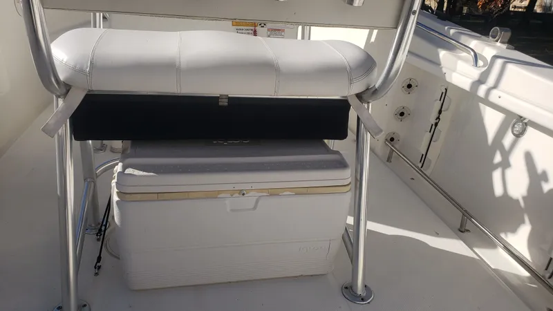 Slide: The Image of Interior of a 2009 Triton 225 CC boat with bench seat and cooler. - 29