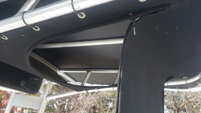 Slide: The Image of Triton 225 CC 2009 boat canopy with zipper and metal frame. - 31
