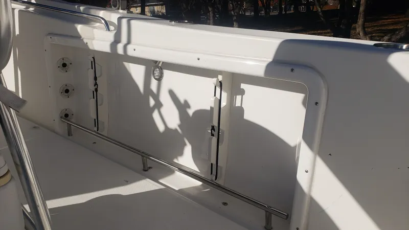 Slide: The Image of Interior view of a 2009 Triton 225 CC boat, white side panel. - 32