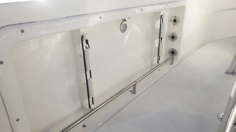 Slide: The Image of Interior view of a 2009 Triton 225 CC boat with storage area. - 33