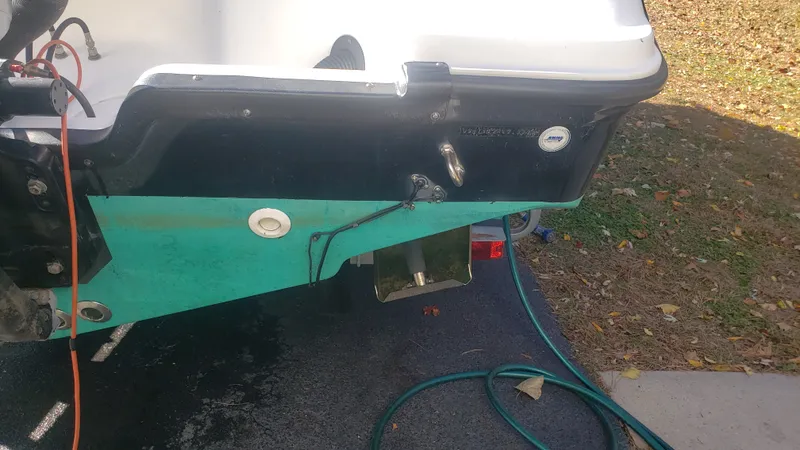 Slide: The Image of Rear view of a 2009 Triton 225 CC boat with hoses and cables. - 35