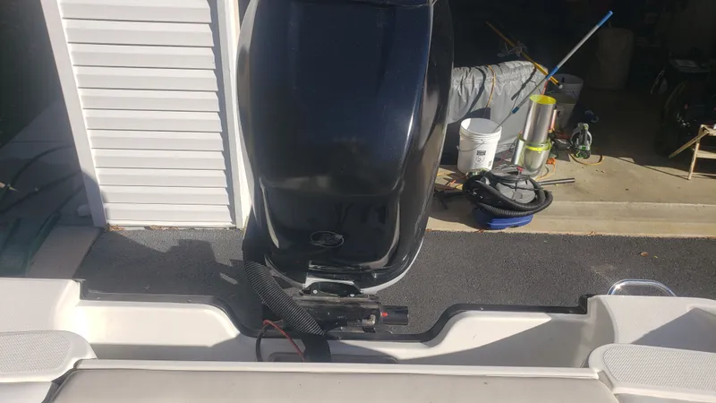 Slide: The Image of 2009 Triton 225 CC boat motor in a garage. - 37