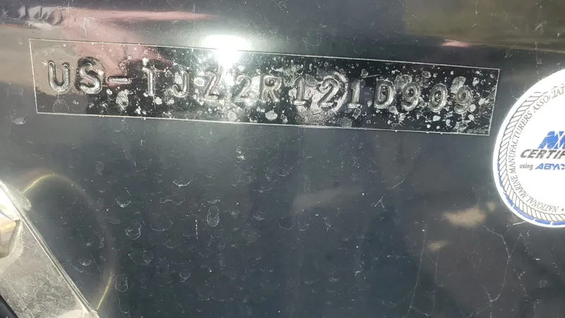 Slide: The Image of Triton 225 CC 2009 serial number and certification label. - 47