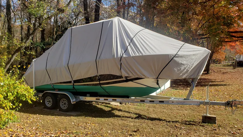 Slide: The Image of 2009 Triton 225 CC boat on trailer with cover in autumn woods. - 7