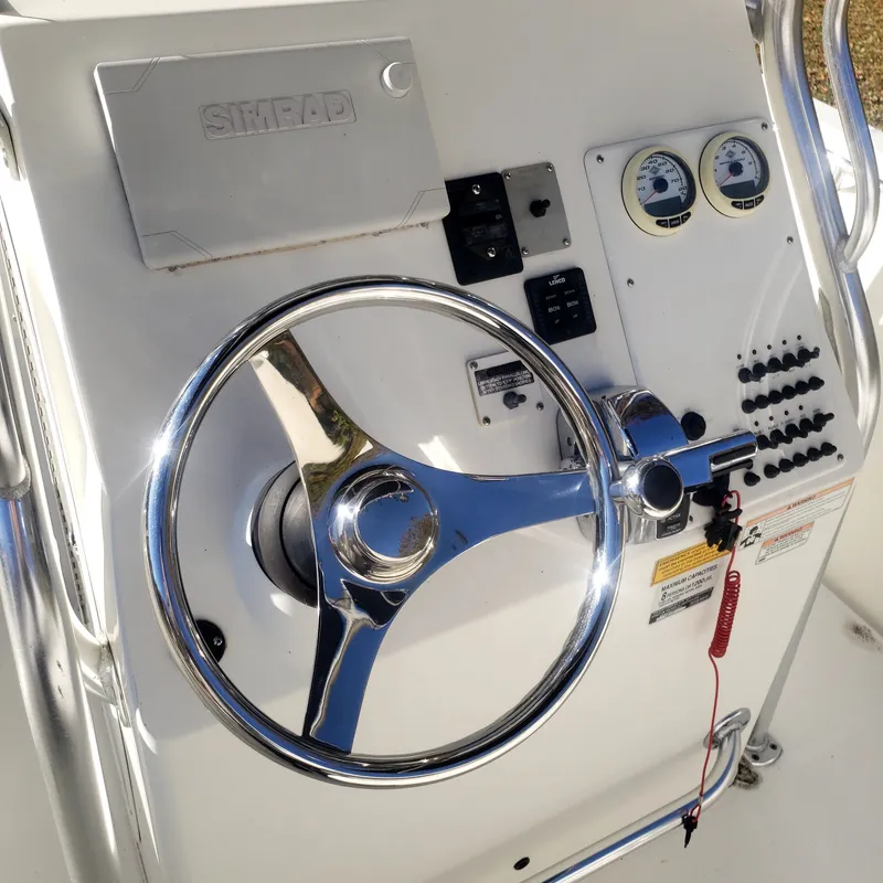 Slide: The Image of 2009 Triton 225 CC boat steering console with instruments. - 9