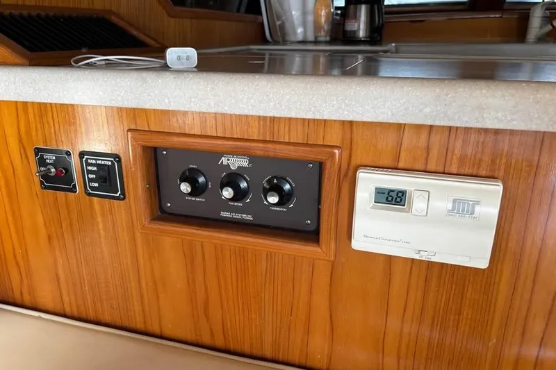 Slide: The Image of 1990 Ocean Alexander 420 Sport Sedan interior controls and thermostat panel. - 10