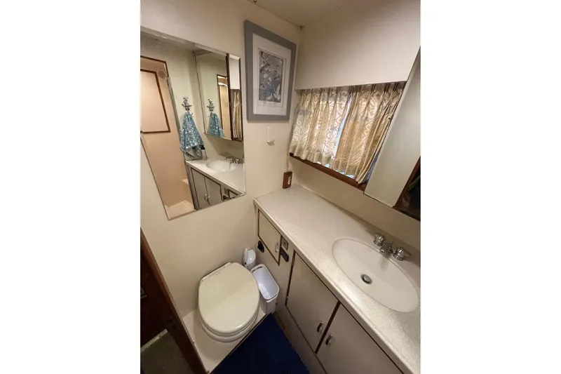 Slide: The Image of Bathroom interior of 1990 Ocean Alexander 420 Sport Sedan yacht, featuring sink and toilet. - 12