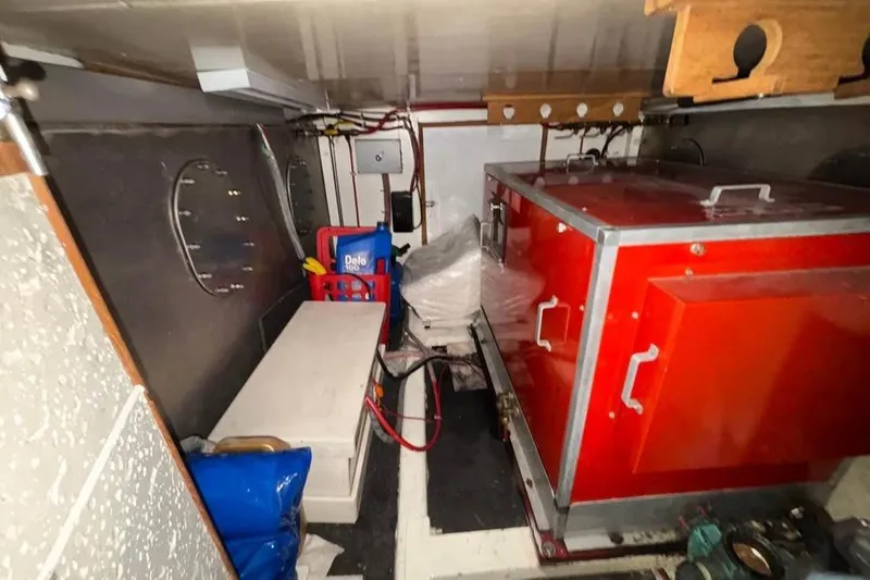 Slide: The Image of Engine room of 1990 Ocean Alexander 420 Sport Sedan with red machinery and storage. - 17