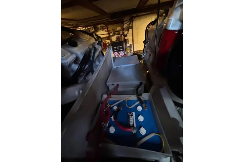 Slide: The Image of Engine room of 1990 Ocean Alexander 420 Sport Sedan with visible battery and wiring. - 19