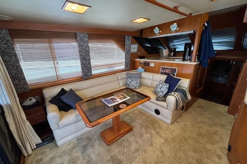 Slide: The Image of Interior of 1990 Ocean Alexander 420 Sport Sedan with cozy seating and wooden accents. - 4