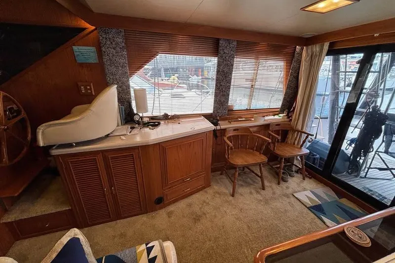 Slide: The Image of Interior of 1990 Ocean Alexander 420 Sport Sedan with wooden furnishings and seating area. - 5