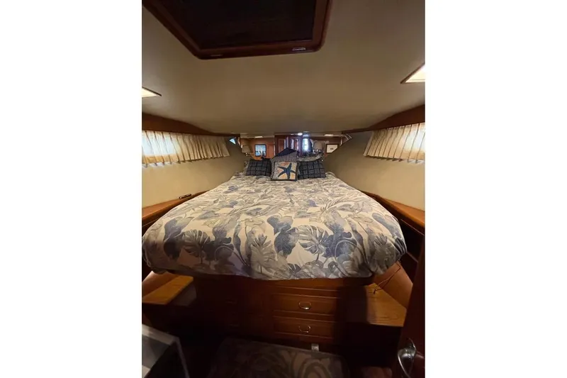 Slide: The Image of Cozy bedroom interior of 1990 Ocean Alexander 420 Sport Sedan yacht with floral bedding. - 7