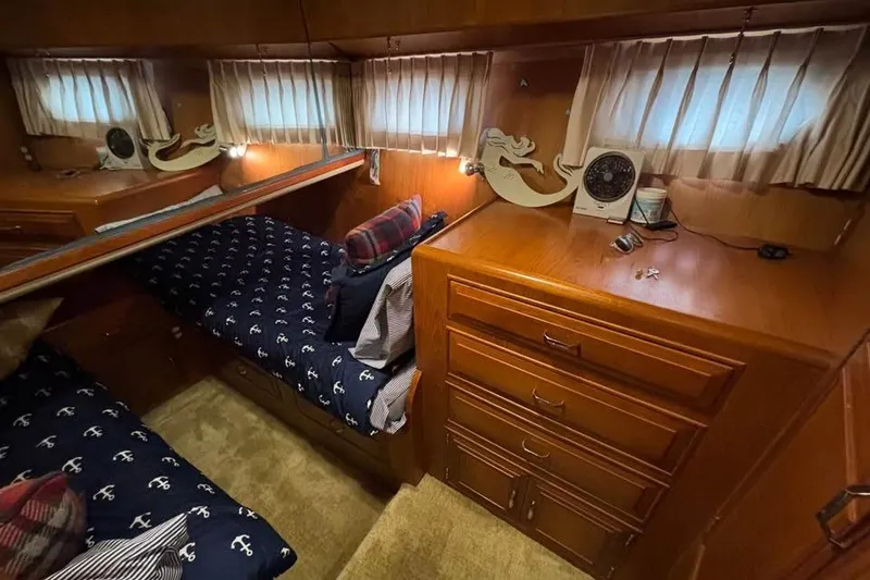 Slide: The Image of Cozy cabin interior of 1990 Ocean Alexander 420 Sport Sedan with nautical bedding. - 8