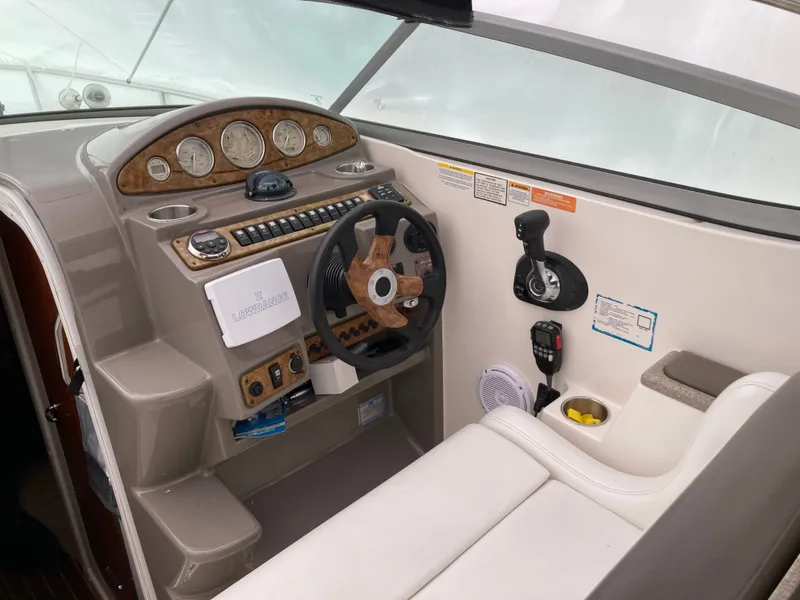Slide: The Image of 2007 Rinker 280 Express Cruiser helm with instruments and steering wheel. - 13