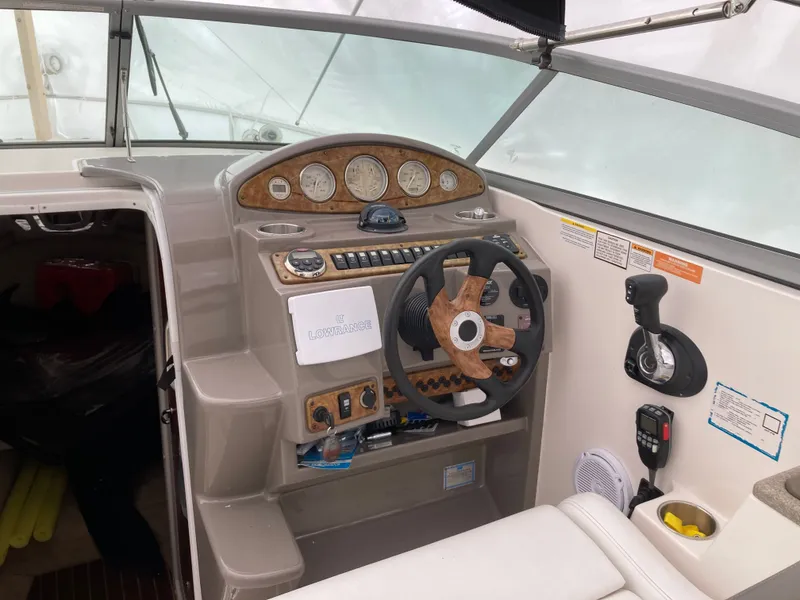 Slide: The Image of 2007 Rinker 280 Express Cruiser helm with wood accents. - 14