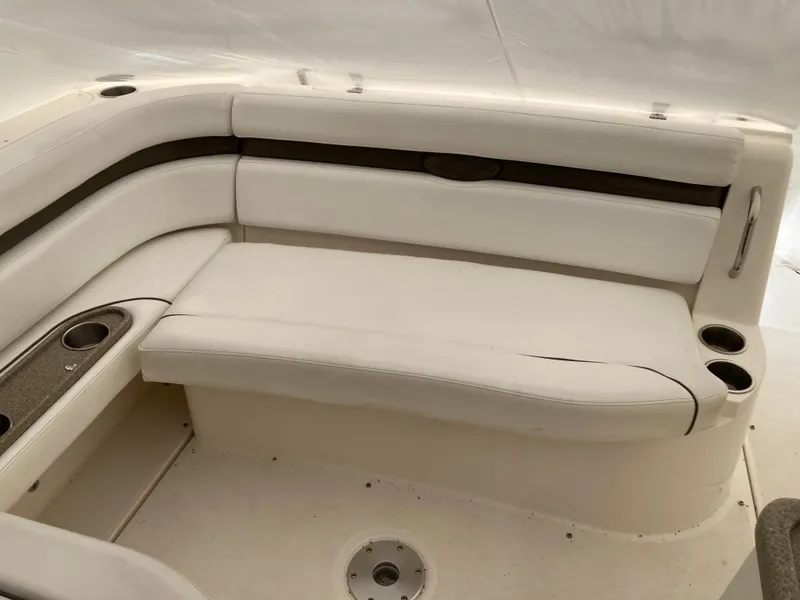 Slide: The Image of Interior of a 2007 Rinker 280 Express Cruiser with white seating. - 16