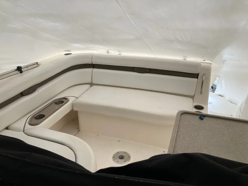 Slide: The Image of Interior of a 2007 Rinker 280 Express Cruiser with white seating. - 20