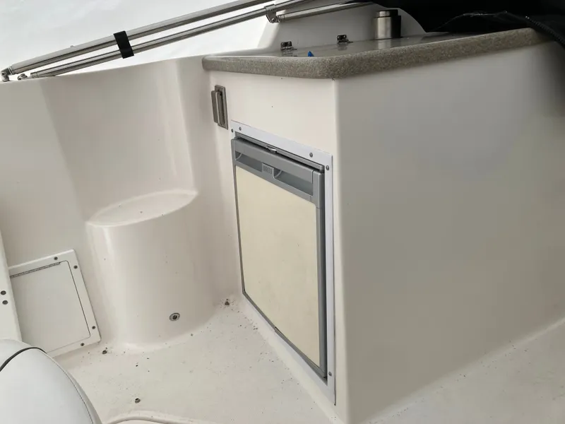 Slide: The Image of Interior of a 2007 Rinker 280 Express Cruiser with refrigerator. - 22