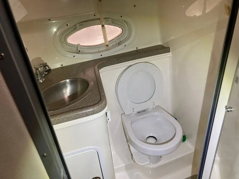 Slide: The Image of 2007 Rinker 280 Express Cruiser bathroom with sink and toilet. - 33