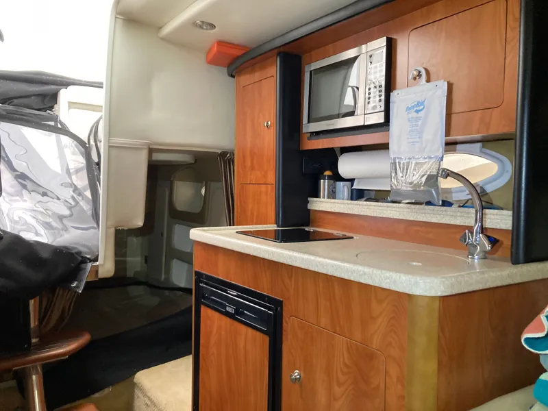 Slide: The Image of Interior of 2007 Rinker 280 Express Cruiser with kitchenette. - 36