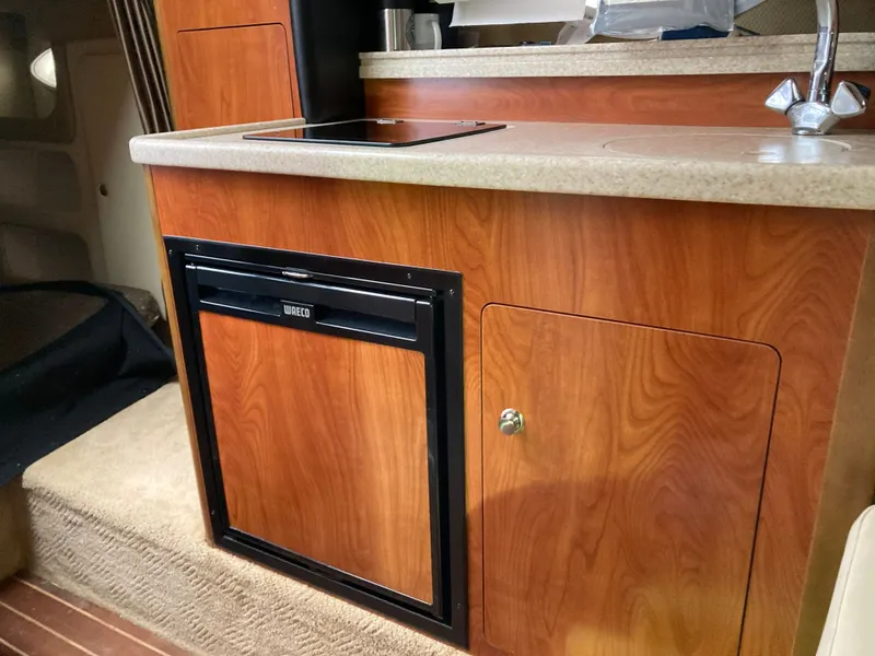 Slide: The Image of Interior of 2007 Rinker 280 Express Cruiser with fridge and sink. - 38