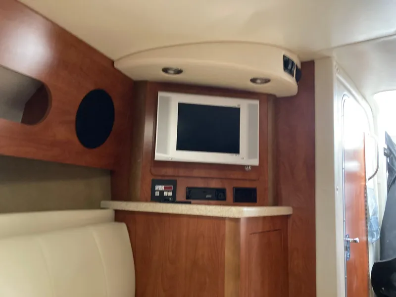 Slide: The Image of Interior of 2007 Rinker 280 Express Cruiser with TV and wood paneling. - 43