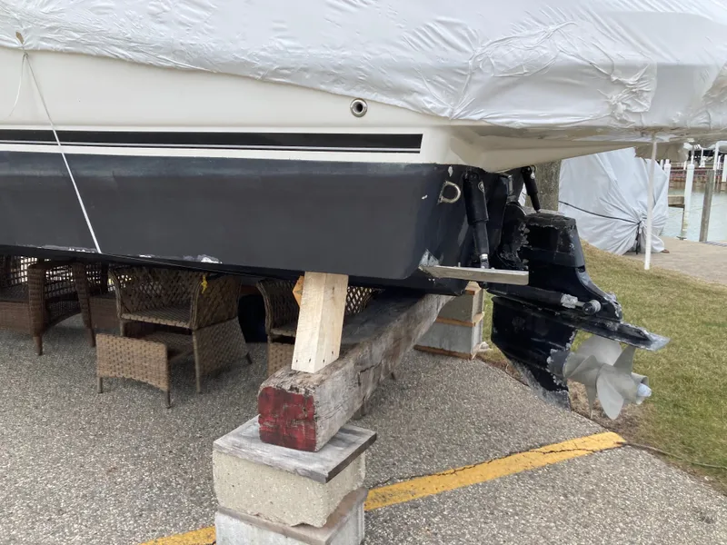 Slide: The Image of 2007 Rinker 280 Express Cruiser propped up with damaged drive. - 5