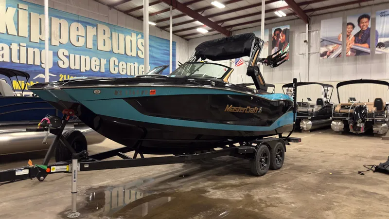 Slide: The Image of 2022 MasterCraft X22 boat in a showroom. - 1