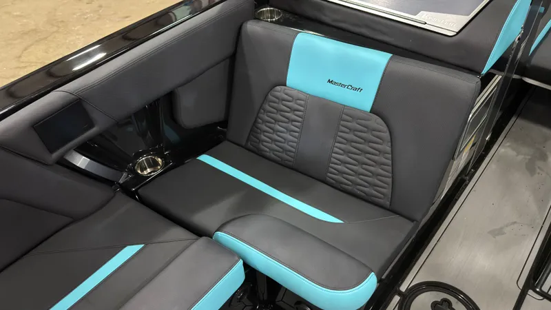 Slide: The Image of MasterCraft X22 2022 boat seat with blue and black design. - 10
