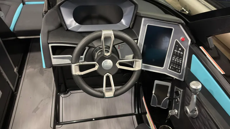 Slide: The Image of Interior of 2022 MasterCraft X22 with steering wheel and control console. - 13