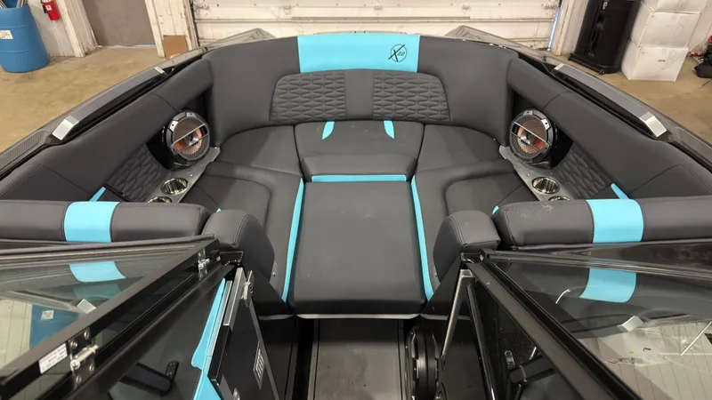 Slide: The Image of Interior of a 2022 MasterCraft X22 boat with blue and gray seating. - 15