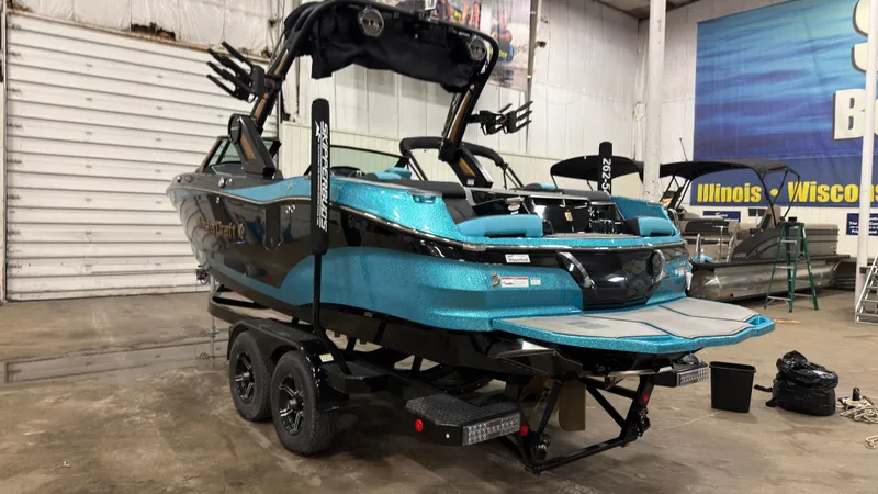 Slide: The Image of 2022 MasterCraft X22 boat in a warehouse setting. - 2