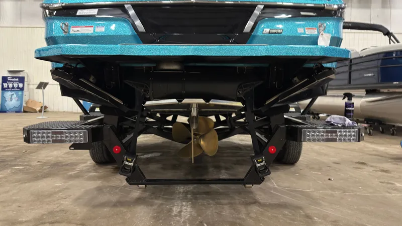 Slide: The Image of Rear view of a 2022 MasterCraft X22 boat in a warehouse. - 4