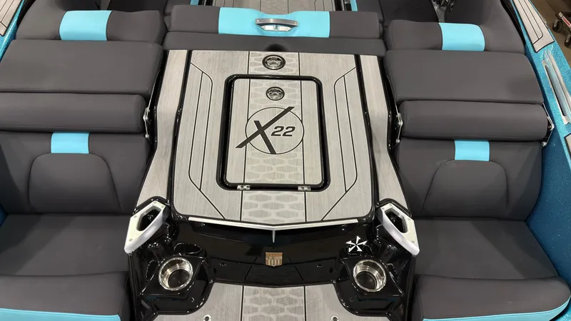 Slide: The Image of Interior of a 2022 MasterCraft X22 boat with gray and blue seating. - 5
