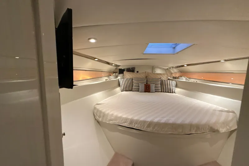 Slide: The Image of Luxurious cabin interior of a 1999 Diaship 53 yacht with skylight and striped pillows. - 13