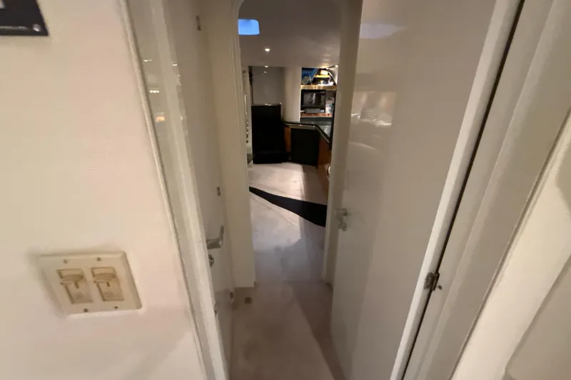 Slide: The Image of Interior view of a 1999 Diaship 53 yacht, featuring a hallway leading to the kitchen area. - 17