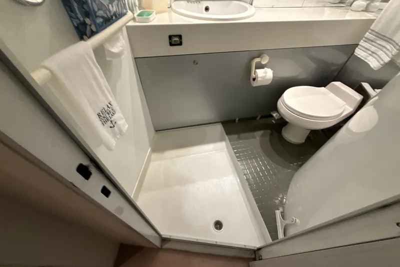 Slide: The Image of Compact bathroom with shower, toilet, and sink in a 1999 Diaship model 53. - 21