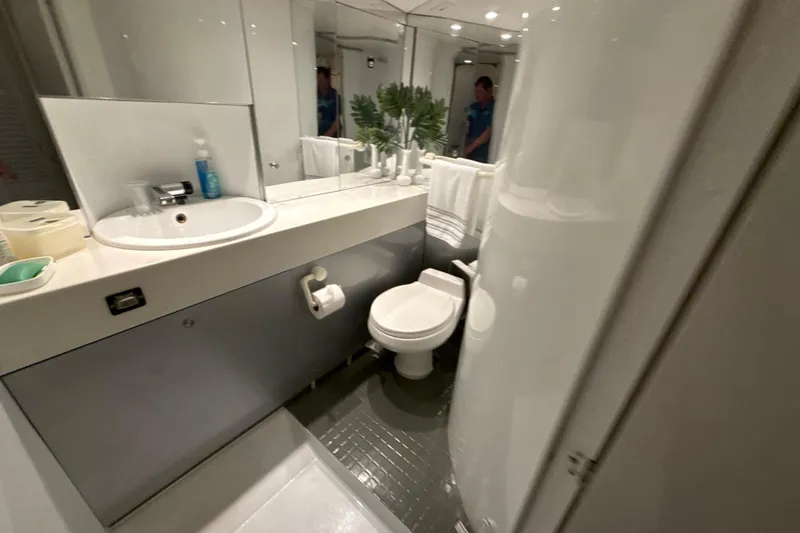 Slide: The Image of Compact bathroom in a 1999 Diaship 53 yacht, featuring sink, toilet, and mirror. - 23
